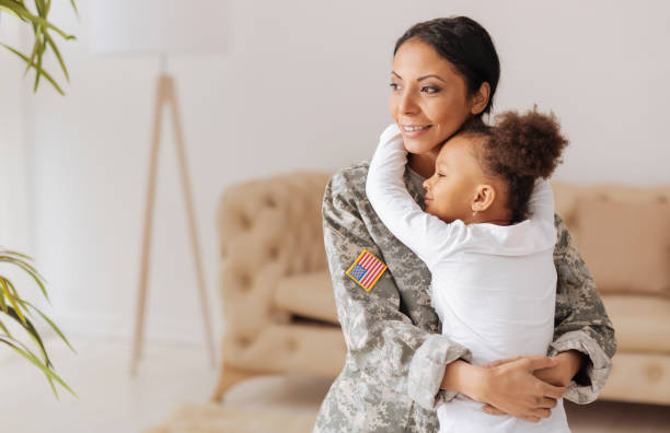 Delighted parent and her child happy to meet again Never letting you go. Attached harming passionate mother and her daughter hugging tightly and enjoying their reunion after mom spending a few month in a training camp soldiers returning home stock pictures, royalty-free photos & images