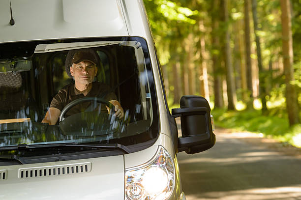 Delivery courier in van on the way stock photo