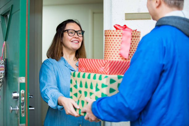 Delivery man bringing holiday packages. stock photo