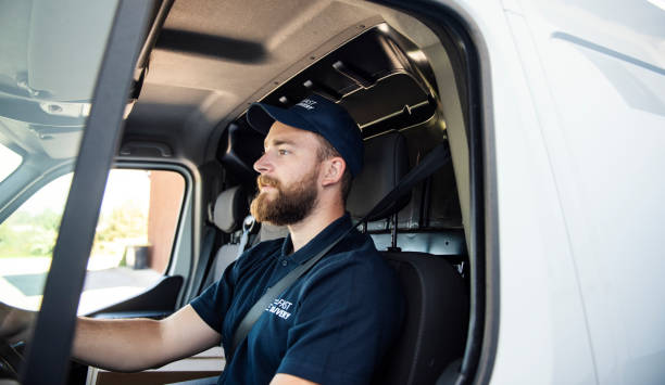 Delivery man sitting in a delivery van  commercial land vehicle stock pictures, royalty-free photos & images