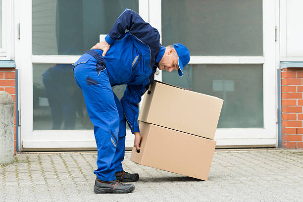Delivery Man Suffering From Backpain Delivery Man Suffering From Backpain While Lifting Boxes picking up stock pictures, royalty-free photos & images