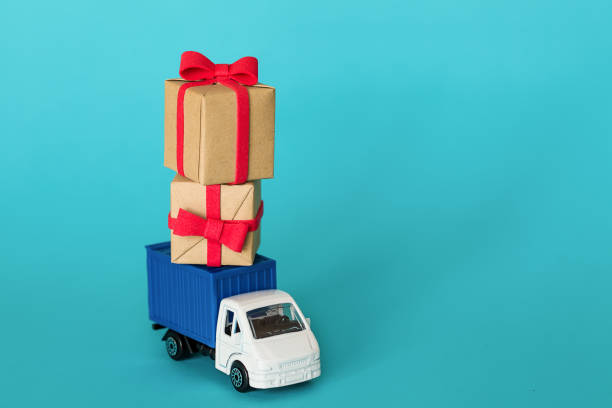 Delivery van with Gifts Boxes. Cargo transportation, delivery service. Transport company. Infrastructure and logistics. Unloading cardboard box. Space for text Car delivering gift box. The concept of saving money. Cargo transportation, delivery service. Transport company. Infrastructure and logistics. Unloading cardboard box. Place for text happy birthday in danish stock pictures, royalty-free photos & images