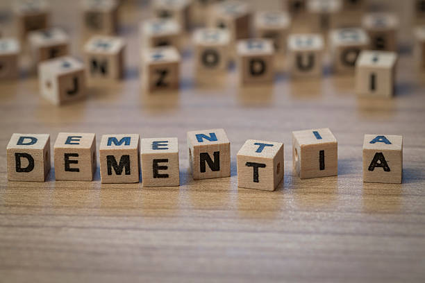 Dementia written in wooden cubes Dementia written in wooden cubes on a table from well ordered to chaotic dementia stock pictures, royalty-free photos & images