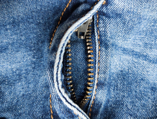 Denim zipper in the middle. Jeans blue, textile. View from above. place for text. Open zipper on jeans. Close-up, fashion concept. Empty space, Copy space. stock photo