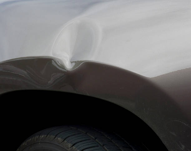 Dent in a car's body from an auto accident  Auto with dented front fender. dented stock pictures, royalty-free photos & images
