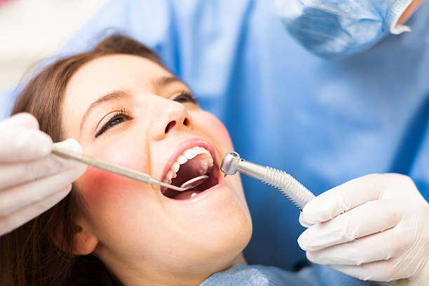 Dental treatment Woman receiving a dental treatment filling stock pictures, royalty-free photos & images