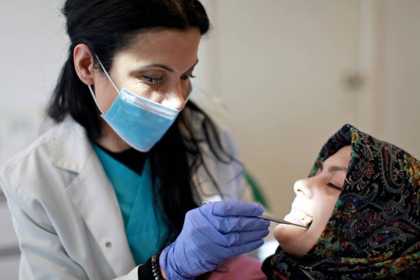 Dentist examining patients stock photo