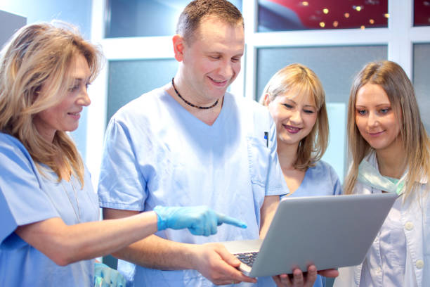 Dentist team working together in dental office. stock photo