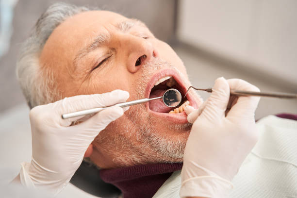 Dentist using sterile equipment while working stock photo