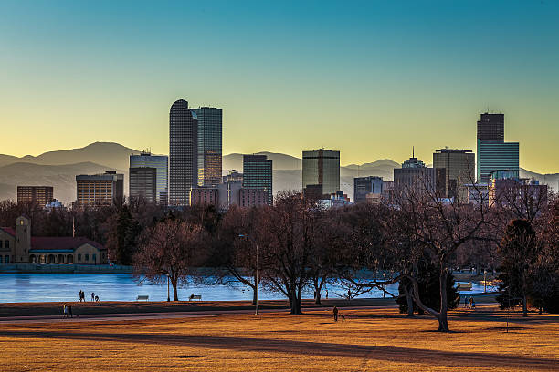 Denver Skyline at Sunset Denver City skyline and City Park at sunset in warm orange glow  2015 photos stock pictures, royalty-free photos & images