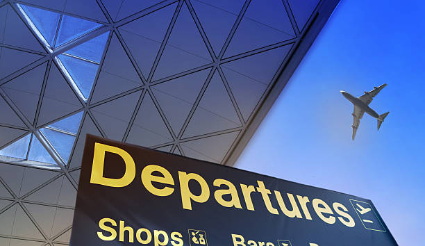 Departure sign in airport Departure sign in airport against of blue sky and plane in the sky arrival departure board stock pictures, royalty-free photos & images