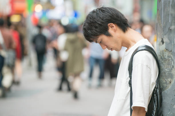 Depressed young man in the city stock photo