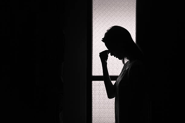 Depression Depressed young woman in a dark room Emotional Pain stock pictures, royalty-free photos & images