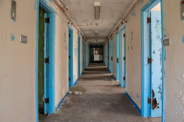 Derelict prison Corridor of prison cell doors inside an abandoned prison. strangford lough stock pictures, royalty-free photos & images