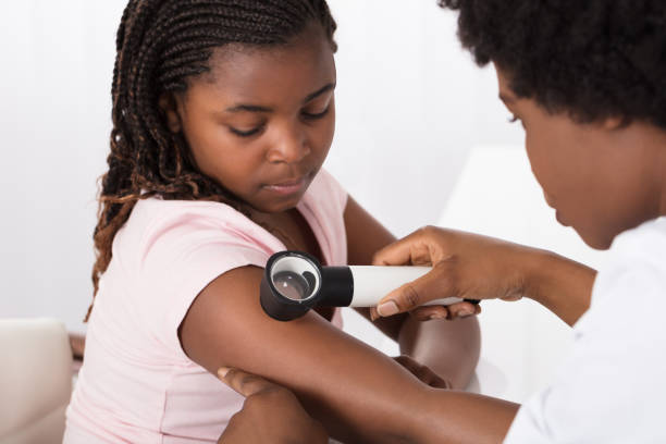 Dermatologist Checking The Child Patient Skin Female Doctor Examining Skin Of Girl With Dermatoscope In A Clinic dermatologist stock pictures, royalty-free photos & images