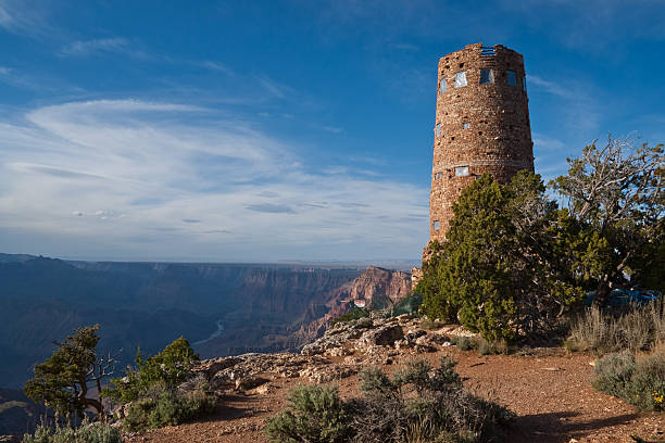 Desert View Watchtower Overlooks the Grand Canyon and Colorado River The Desert View Watchtower is a 70-foot high stone building located on the South Rim within Grand Canyon National Park in Arizona, USA. The four-story historic structure, completed in 1932, was designed by American architect Mary Colter who also created and designed many other buildings in the Grand Canyon vicinity including Hermit's Rest and the Lookout Studio. south rim stock pictures, royalty-free photos & images