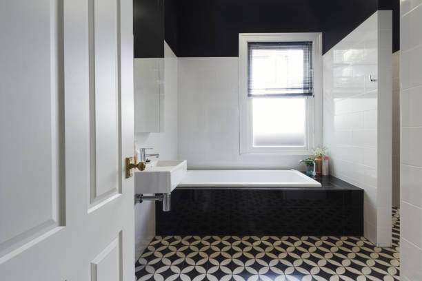 Designer bathroom renovation with black and white floor tiles horizontal stock photo