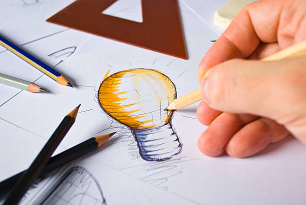 Designer Drawing A designer drawing sketches graphic designer stock pictures, royalty-free photos & images
