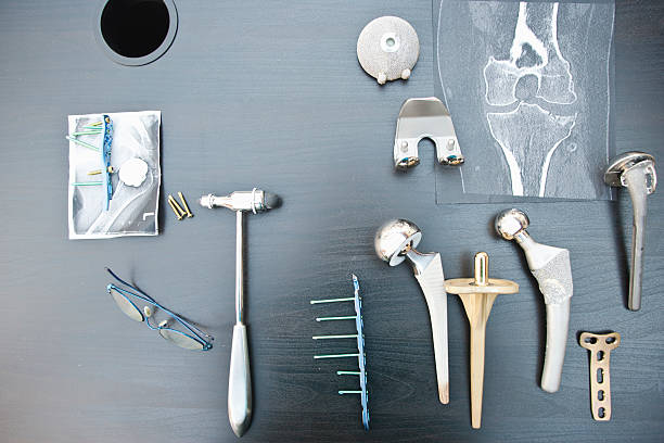 Desk of an orthopedic surgeon with different types of arthroplasties The desk of an orthopedic surgeon with different types of arthroplasties. Hip, shoulder, knee, philos plates... x ray plates stock pictures, royalty-free photos & images