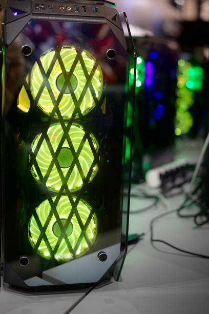 Desktop computer illuminated by green LED light stock photo