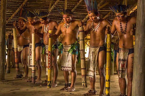 Dessana tribe dance ritual in Amazon Brazil Manaus, Brazil - March 8, 2015: Brazilian indigenous from the Dessana tribe show their ritual during an expedition at the Rio Negro River in the Amazon rainforest. indigenous culture stock pictures, royalty-free photos & images