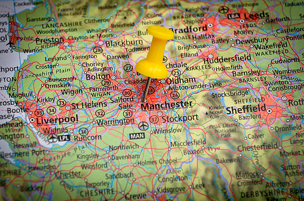 Destination Manchester, UK, on geographical map in close up image Detail of the geographic map with yellow pin northwest england stock pictures, royalty-free photos & images