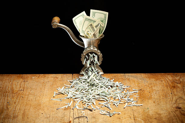 Destroying Dollars with a grinder stock photo