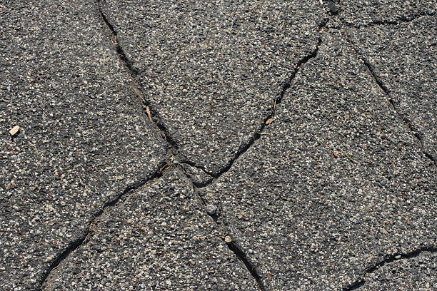 Detail of a cracked asphalt road stock photo
