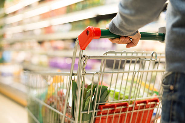 detail of a man shopping in supermarket - boodschappen stockfoto's en -beelden