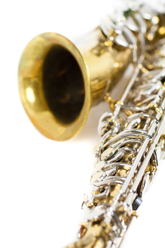 detail of a gold and silver brass saxophone in white background