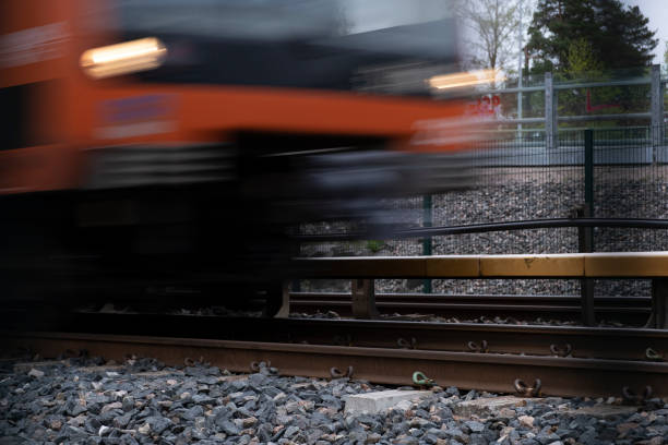 A detail of an underground rails with a blurred metro passing by. stock photo