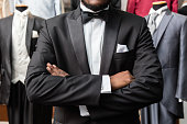istock Detail of arms crossed of african-american man man dressing tuxedo at tailor ahop 1336753655