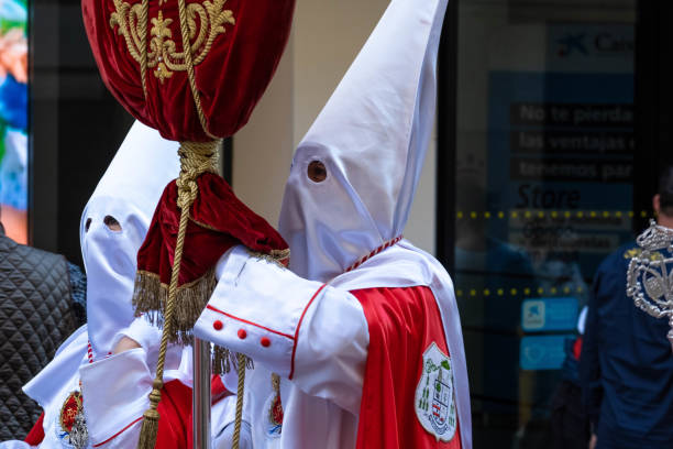 Detail of Nazarene holding long metal rods during the Good Friday procession in Badajoz, Spain stock photo