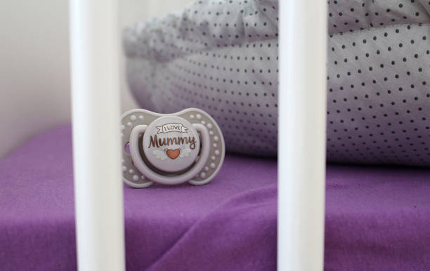 Detail of nice pacifier in child cot stock photo