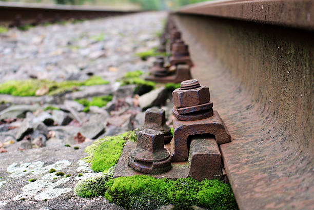 Detail of rail screw at abandoned train track stock photo