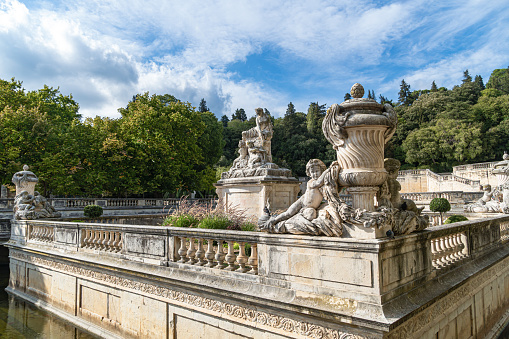 Detail of the beautiful fountain in the Jardin de la fontaine in Nimes, France