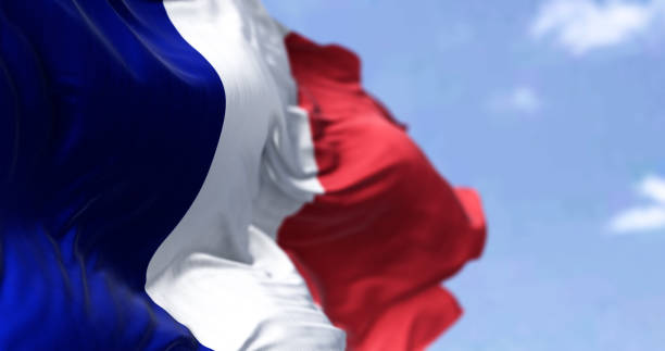 Detail of the national flag of France waving in the wind on a clear day stock photo