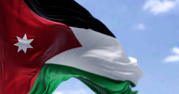 Detail of the national flag of Jordan waving in the wind on a clear day stock photo