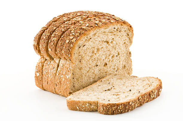 detailed close-up of sliced grain bread on white background - brood stockfoto's en -beelden