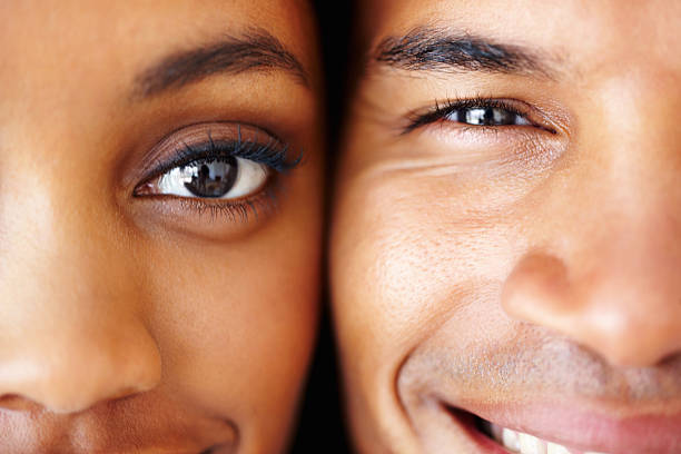 Detailed shot of couple Detailed shot of young African American couple smiling together eye close up stock pictures, royalty-free photos & images