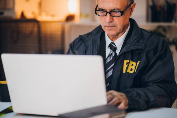 dedektif laptop kullanıyor - fbi stok fotoğraflar ve resimler