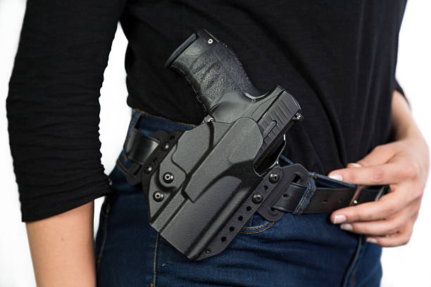 Detective with gun on her belt Detective wearing a gun in a holster on her belt gun violence stock pictures, royalty-free photos & images