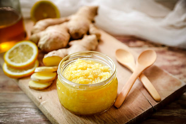 Detox mix of fresh ginger root, honey and lemon stock photo