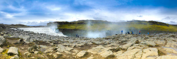 Dettifoss, North Iceland: Tourists Admiring Waterfall, Panoramic Shot Dettifoss, North Iceland: Tourists Admiring Waterfall, Panoramic Shot iceland dettifoss stock pictures, royalty-free photos & images