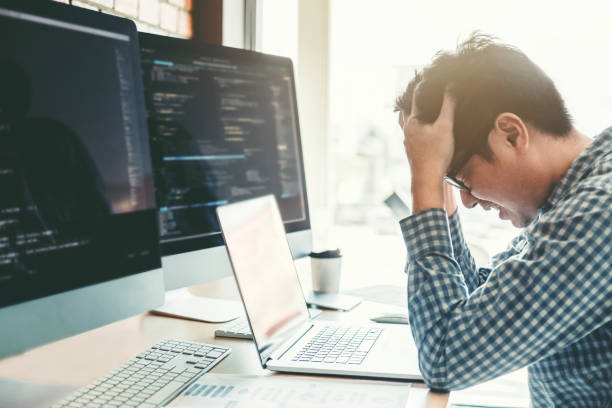Developing programmer stressed out of work. Development Website design and coding technologies working in software company office stock photo