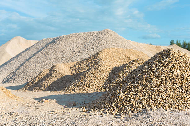 development of rock pile of limestone quarry on background of blue sky gravel stock pictures, royalty-free photos & images