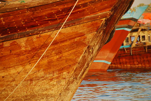 Dhow boat stern Dhows are traditional ships that ply between Middle East, Africa and India. This picture is taken in dubai at the dubai creek. dhow stock pictures, royalty-free photos & images