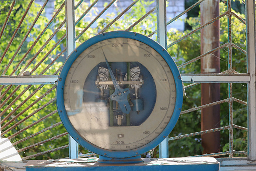Dial of very old retro vintage industrial analog scales for weighing crops and harvest. Selective focus