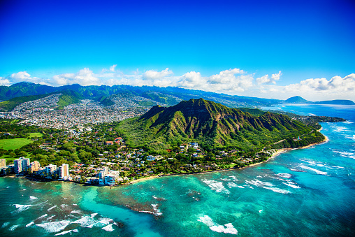 The dormant volcano known as Diamond Head located adjacent to downtown Honlulu, Hawaii, as shot from an altitude of about 1500 feet over the Pacific Ocean.