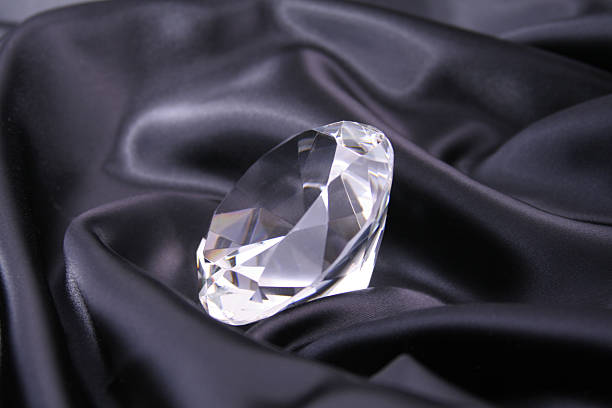Diamond on black satin stock photo